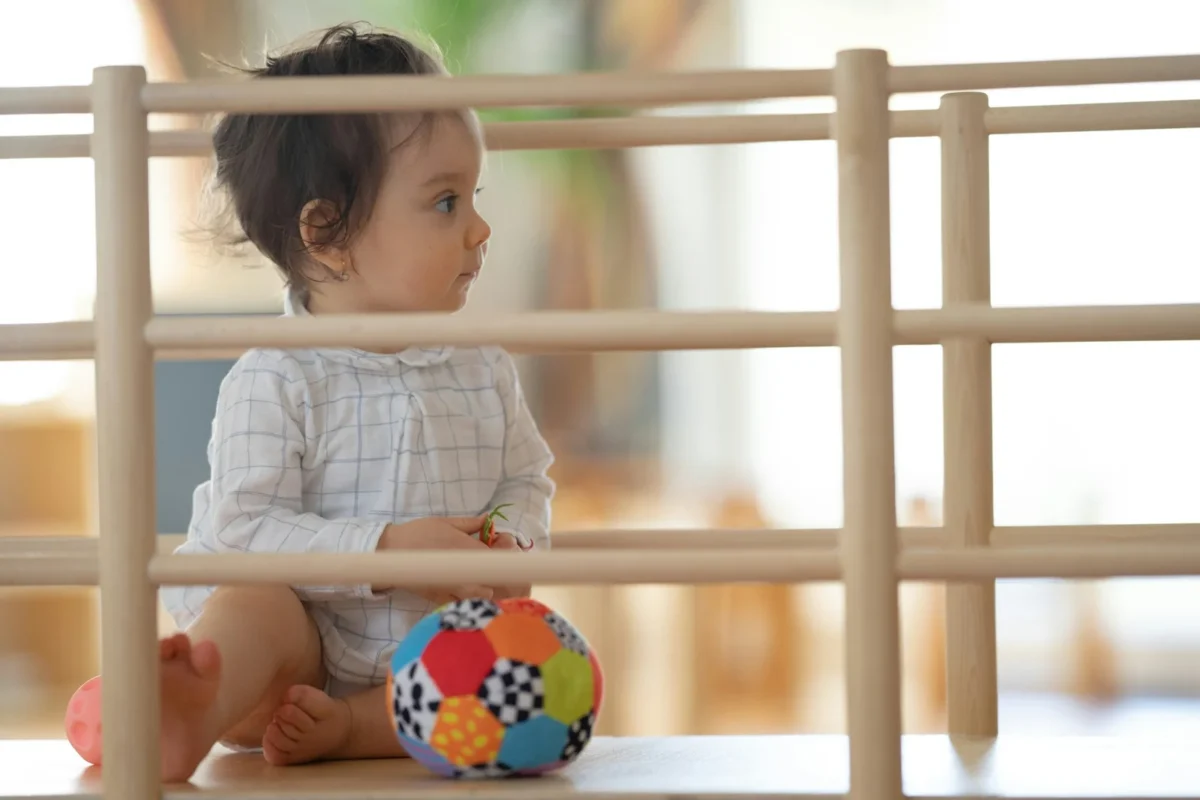 a baby playing with a ball