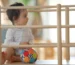 a baby playing with a ball